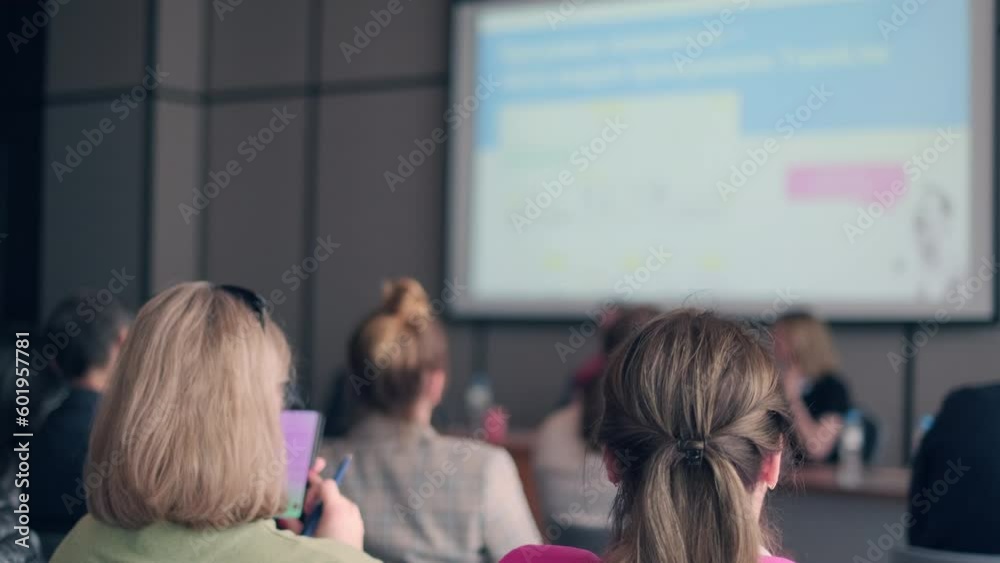 People attending symposium sitting in conference hall People attending symposium sitting in conference hall
