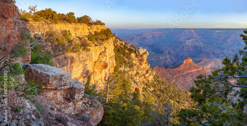 The last rays of the setting sun illuminate the majestic Grand Canyon.