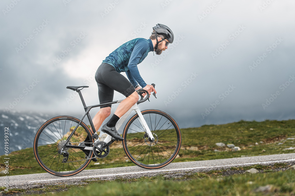 Fototapeta premium Cyclist athlete pedals uphill