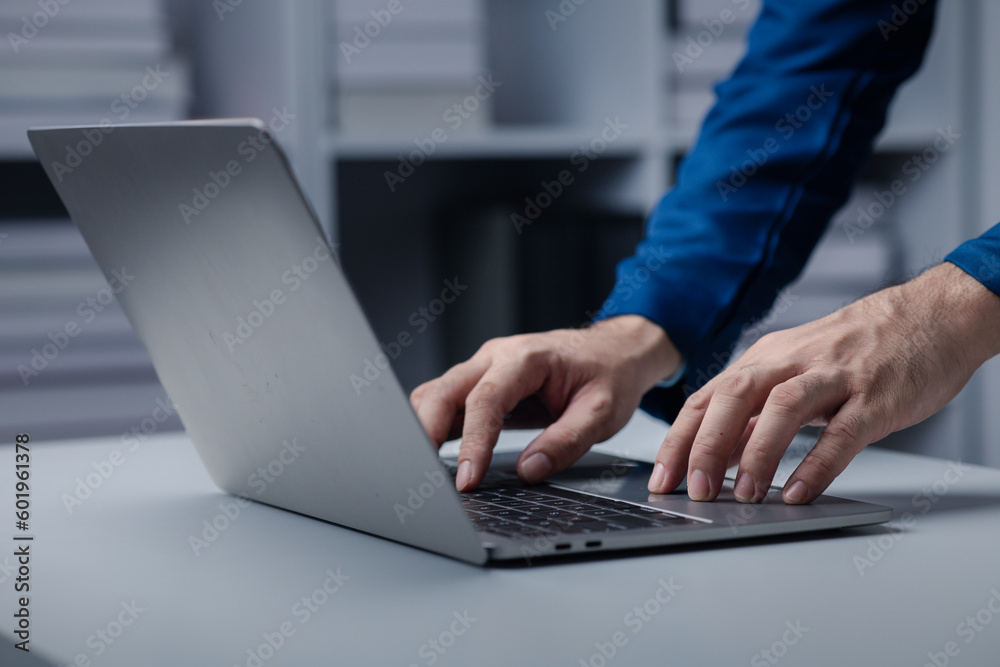 Person typing on laptop keyboard, businessman working on laptop, he is typing messages to colleagues and making financial information sheet to sum up the meeting. Person typing on laptop keyboard, businessman working on laptop, he is typing messages to colleagues and making financial information sheet to sum up the meeting.