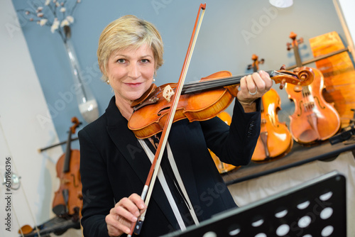 an elderly lady playing violin