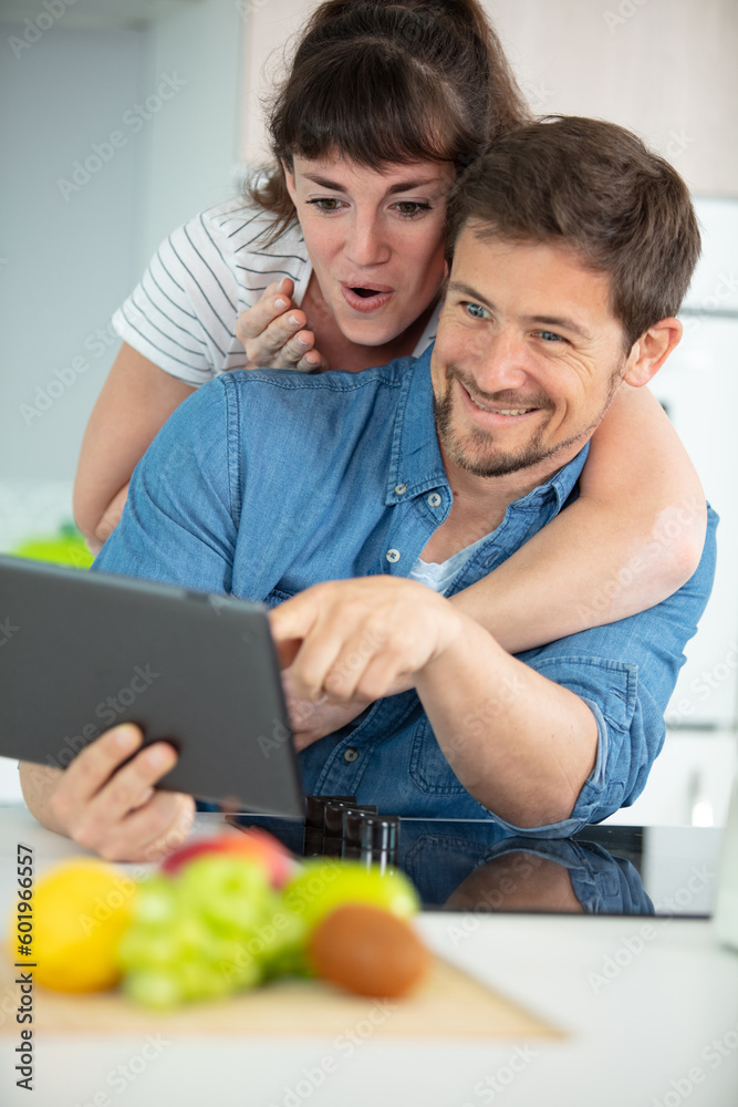 couple using digital tablet while cooking couple using digital tablet while cooking