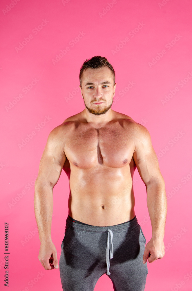 Fototapeta premium Young handsome guy on a diet. A man with a beautiful athletic body.