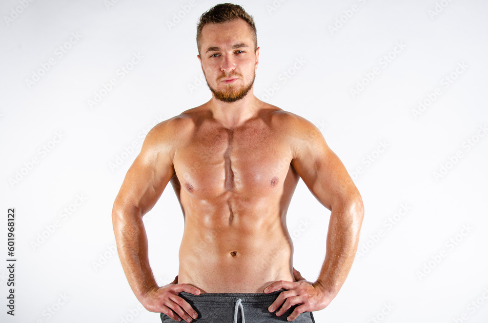 Fototapeta premium Young handsome guy on a diet. A man with a beautiful athletic body. 