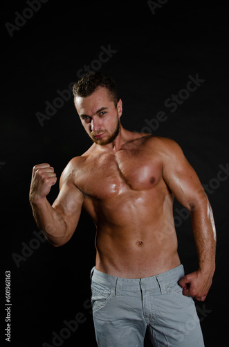 Young handsome guy on a diet. A man with a beautiful athletic body.  © vladorlov