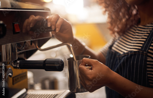 Coffee machine, hands and barista steam milk in cafe for latte, espresso and cappuccino drinks. Closeup of waitress, jug and hot beverage for heating in caffeine process, restaurant service and store