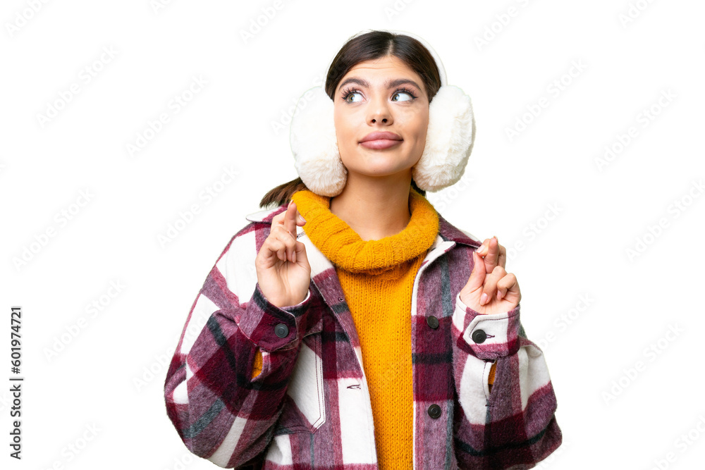 Young Russian woman wearing winter muffs over isolated chroma key background with fingers crossing Young Russian woman wearing winter muffs over isolated chroma key background with fingers crossing