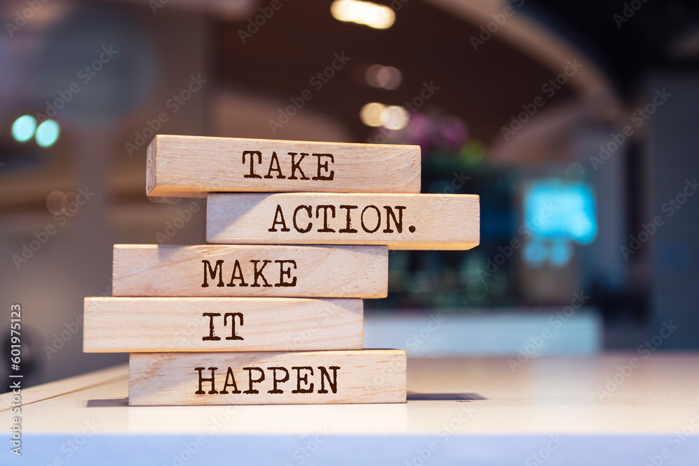 Wooden blocks with words 'Take action. Make it happen'.