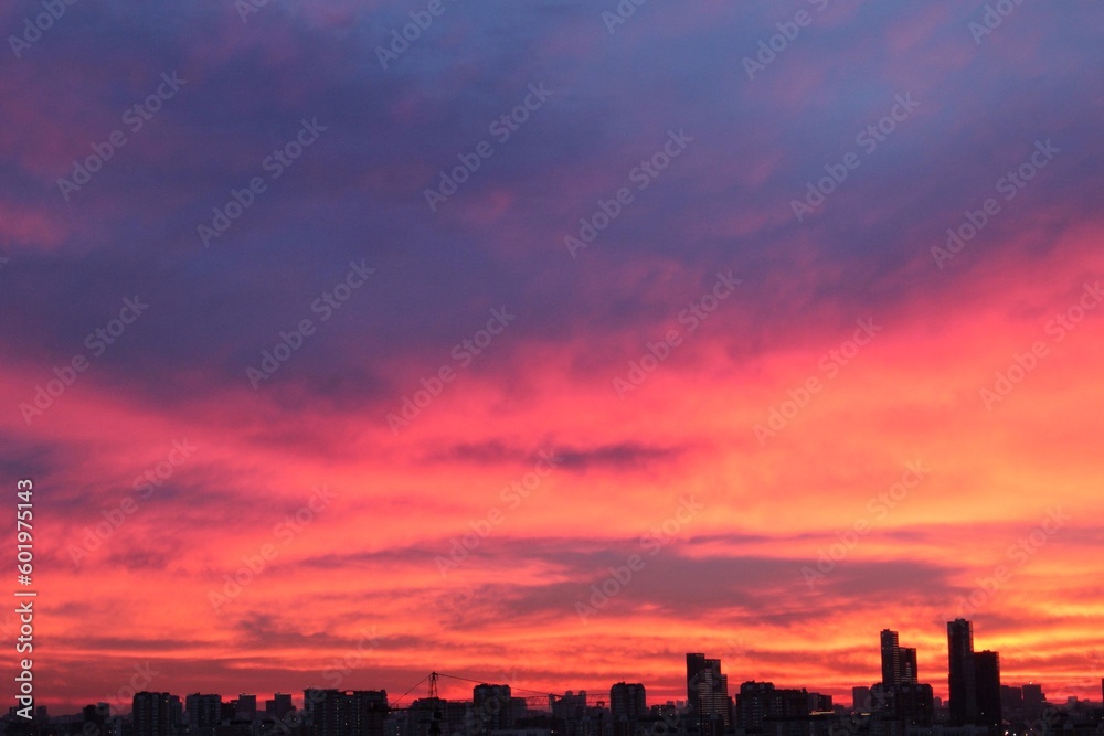 Colorful cloudy twilight beautiful sky cityscape sunset and morning sunrise. Dramatic evening night early morning view with city buildings silhouette. Panoramic background concept. Copy space for text