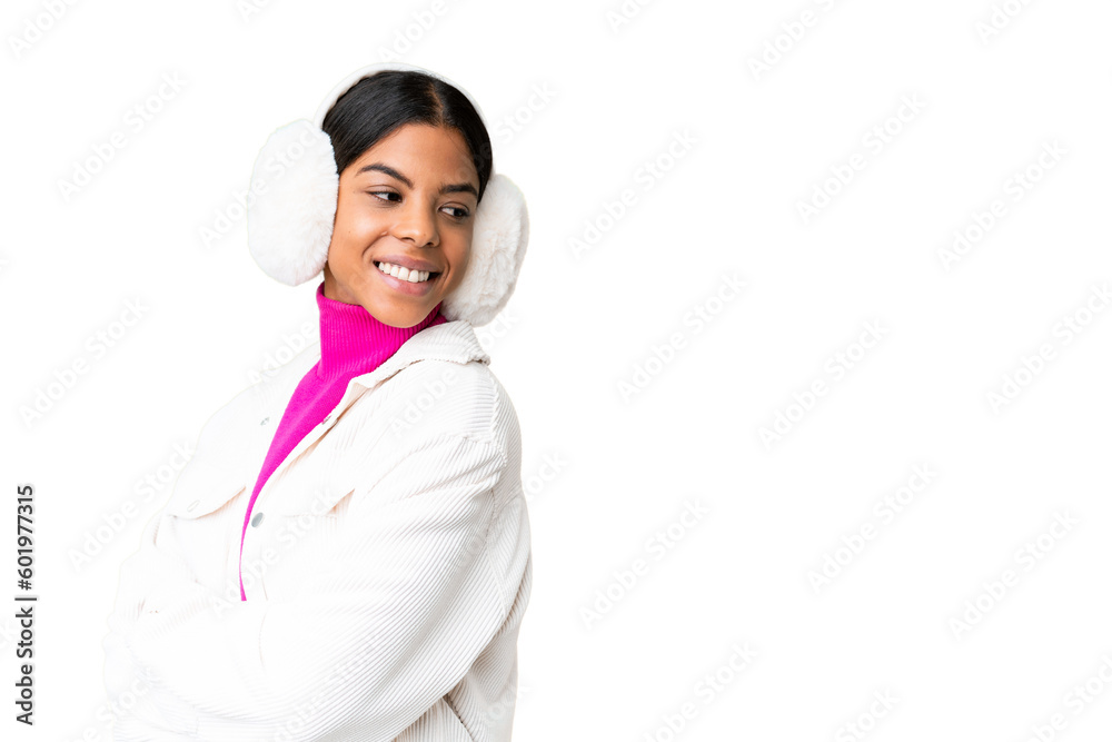 Young African American woman wearing winter muffs over isolated chroma key background with arms crossed and happy Young African American woman wearing winter muffs over isolated chroma key background with arms crossed and happy