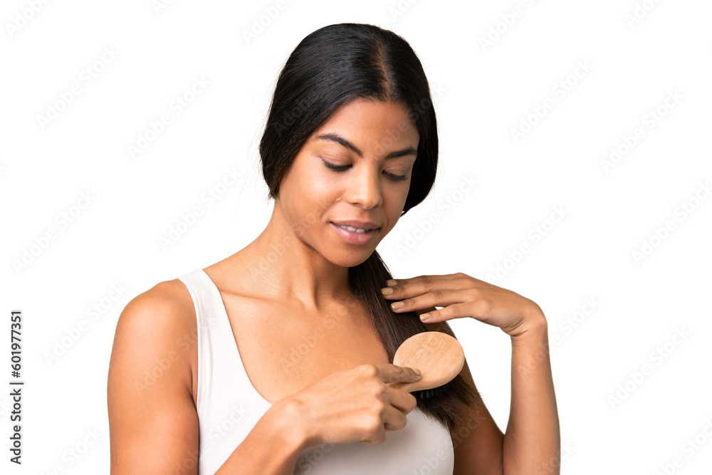 Young woman over over isolated chroma key background with hair comb Young woman over over isolated chroma key background with hair comb