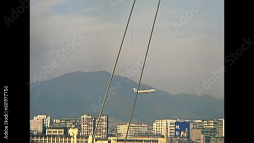 HONG KONG, CHINA - CIRCA 1980: airplane in Hong Kong skyline, view from Hong Kong port Victoria Harbour. Historic restored archival footage on 1980s. photo