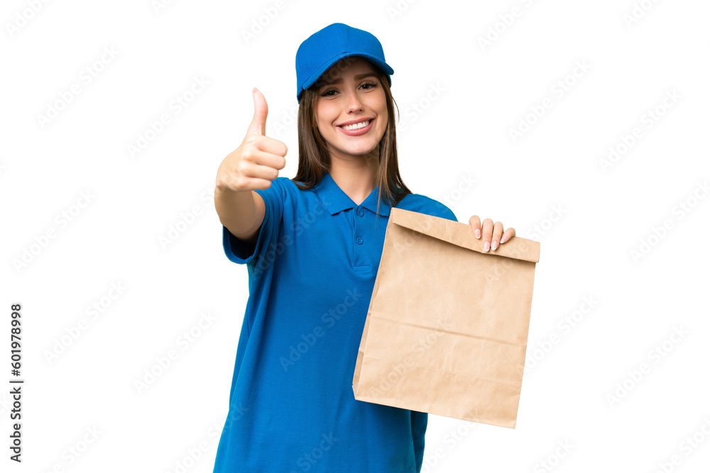 Young beautiful caucasian woman taking a bag of takeaway food over isolated background with thumbs up because something good has happened Young beautiful caucasian woman taking a bag of takeaway food over isolated background with thumbs up because something good has happened