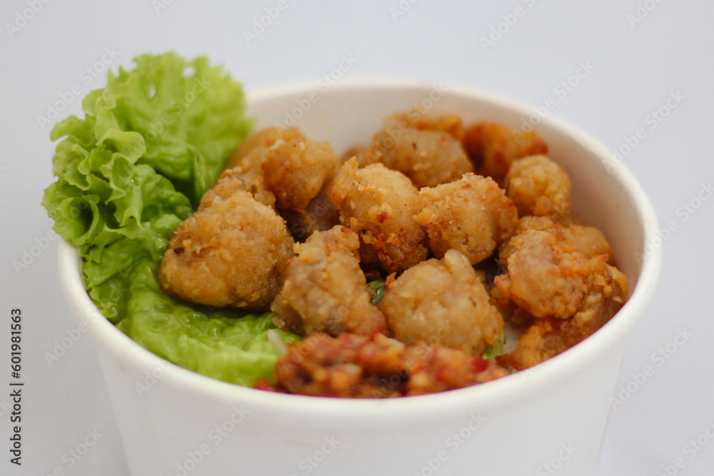 A rice bowl with a green leafy salad A rice bowl with a green leafy salad