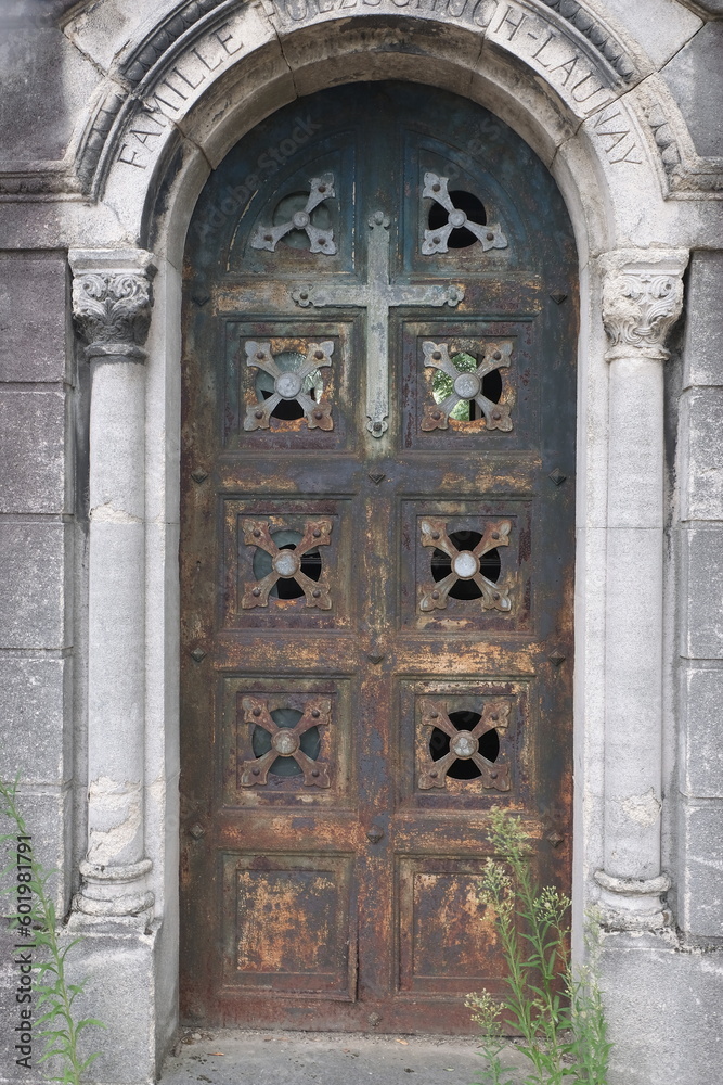 Rust deteriorations. Really old and decrepit door from a century-old cemetery (Père Lachaise, France)