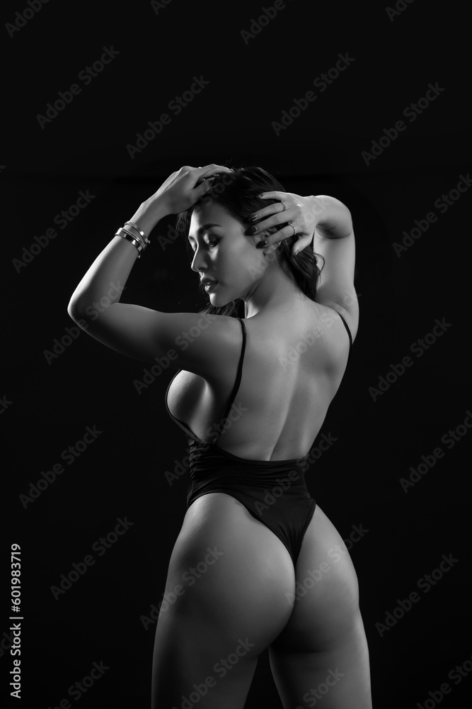 Rear view of sexy woman with fit body on black background. Asien woman standing with her back to camera. black and white
Rear view of sexy woman with fit body on black background. Asien woman standing with her back to camera. black and white