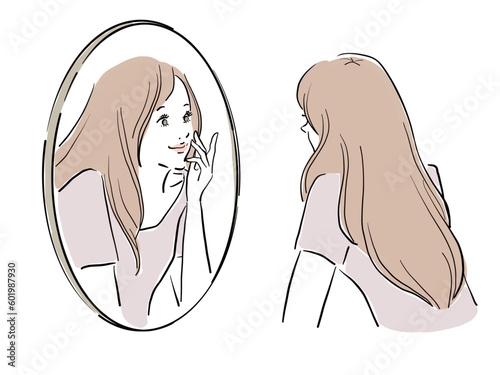 鏡を覗き込むロングヘアの女性