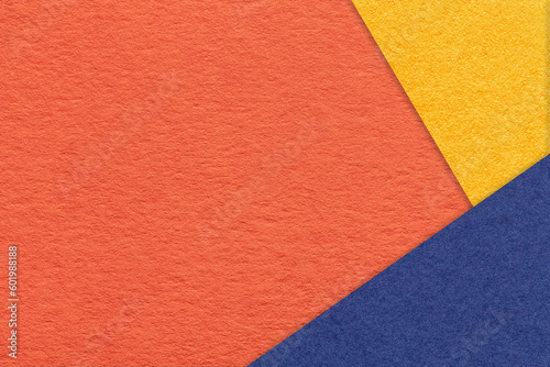 Texture of craft orange color paper background with yellow and blue border. Vintage abstract ginger cardboard.