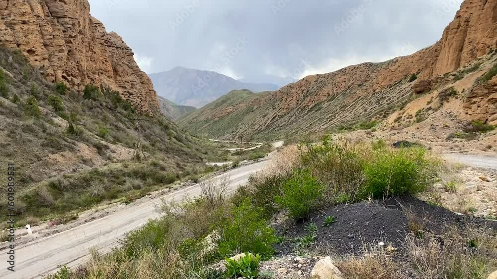 Picturesque view of the serpentine mountain roads. The amazing nature of Kyrgyzstan. Beautiful mountain landscape. Picturesque view of the serpentine mountain roads. The amazing nature of Kyrgyzstan. Beautiful mountain landscape.