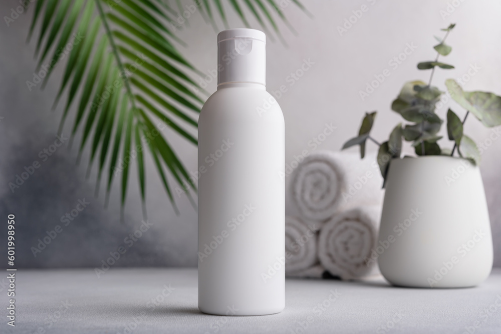 White blank packaging cosmetic plastic bottle with palm leaves - obrazy, fototapety, plakaty 