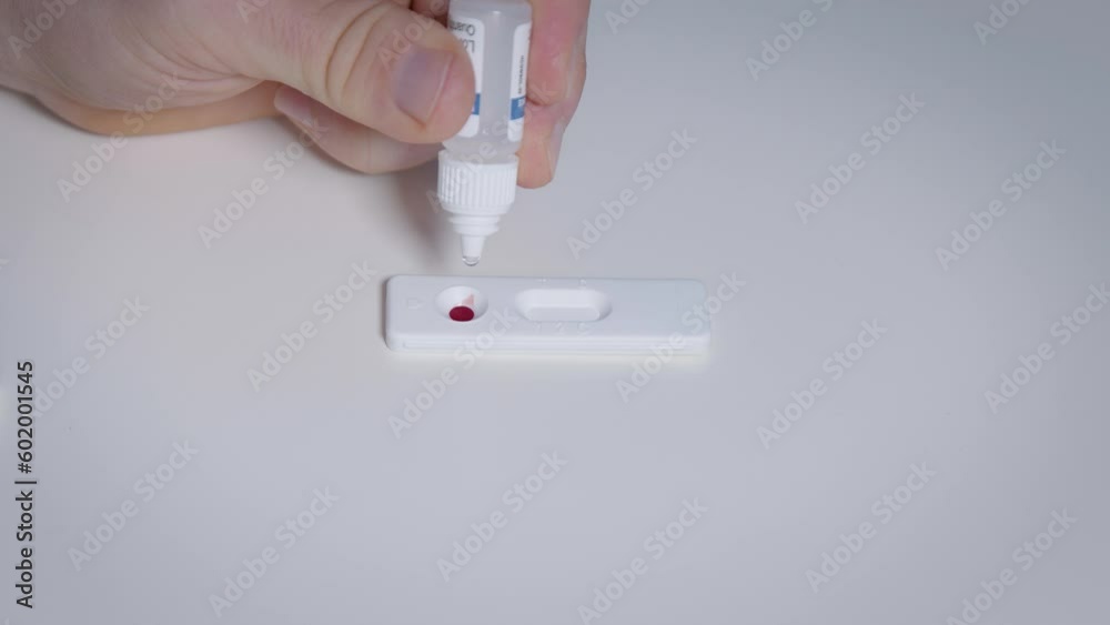 Add drops of diluent, buffer solution into immunological rapid test ...