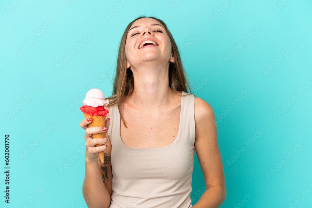 Young Lithuanian woman with cornet ice cream isolated on blue background laughing Young Lithuanian woman with cornet ice cream isolated on blue background laughing
