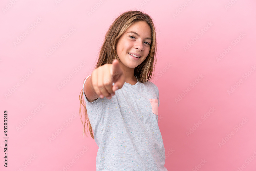 Little caucasian girl isolated on pink background pointing front with happy expression Little caucasian girl isolated on pink background pointing front with happy expression