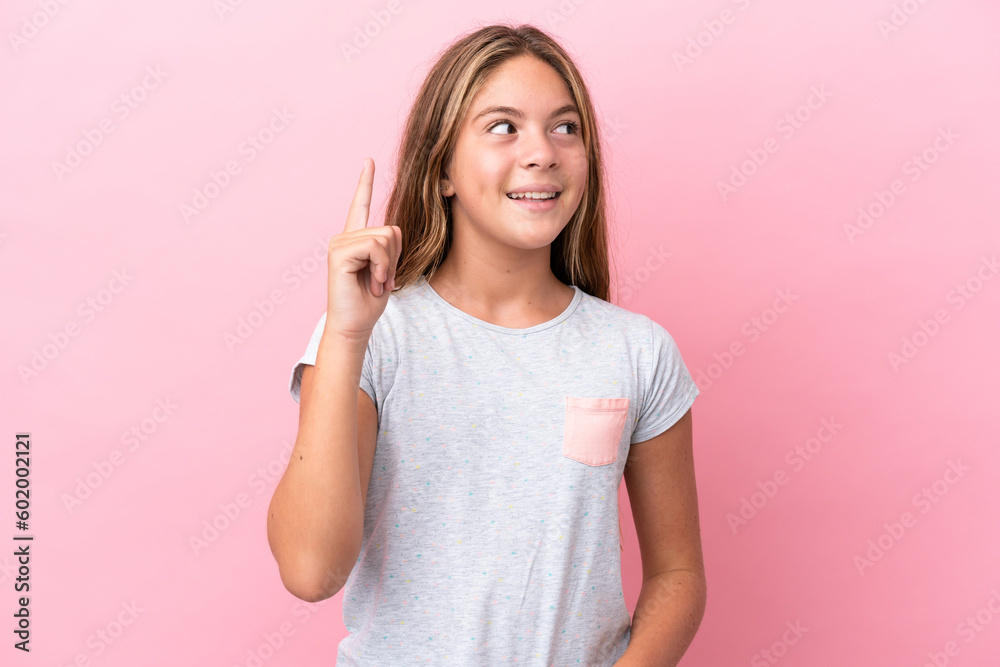 Little caucasian girl isolated on pink background intending to realizes the solution while lifting a finger up Little caucasian girl isolated on pink background intending to realizes the solution while lifting a finger up