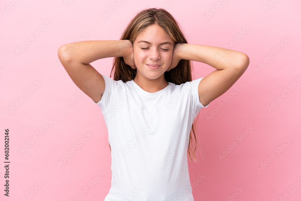 Little caucasian girl isolated on pink background frustrated and covering ears Little caucasian girl isolated on pink background frustrated and covering ears
