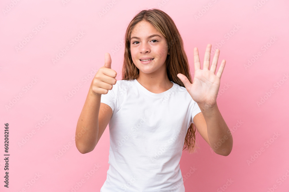 Little caucasian girl isolated on pink background counting six with fingers Little caucasian girl isolated on pink background counting six with fingers