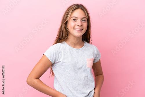 Little caucasian girl isolated on pink background laughing