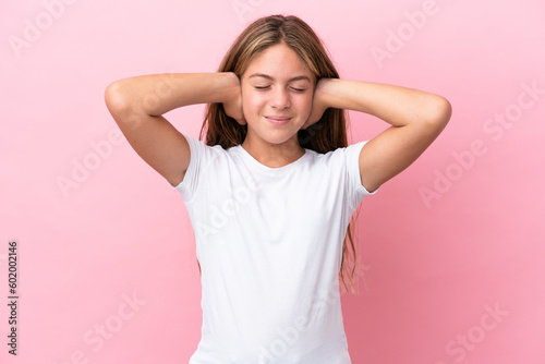 Little caucasian girl isolated on pink background frustrated and covering ears
