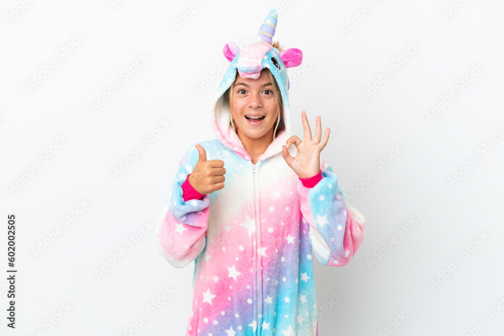 Little girl with unicorn pajamas isolated on white background showing ok sign and thumb up gesture