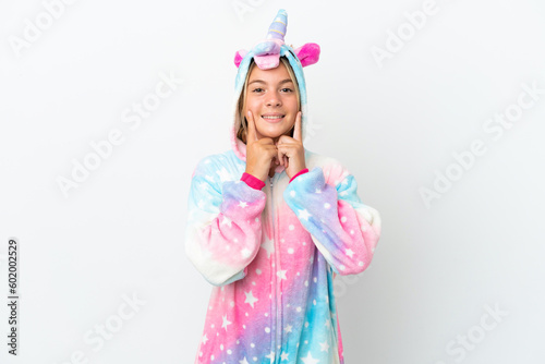 Little girl with unicorn pajamas isolated on white background smiling with a happy and pleasant expression