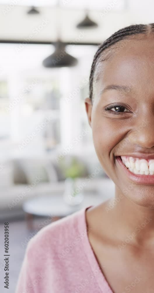 Vertical video of portrait of happy african american woman at home in slow motion