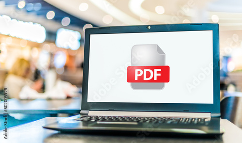 Laptop computer displaying icon of PDF file photo