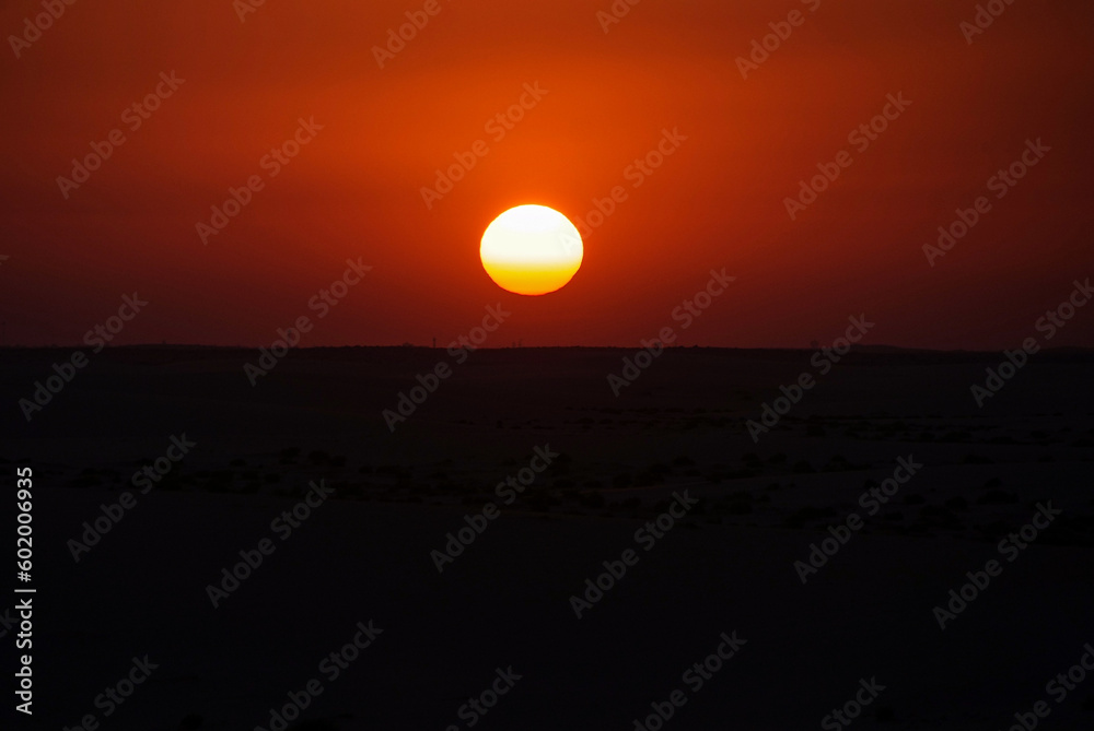 Sunset and sunrise in the desert with beautiful sand dunes behind it
Sunset and sunrise in the desert with beautiful sand dunes behind it