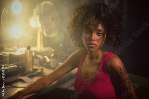  Young woman with natural afro hair in front of her make-up mirror in a hazy atmosphere