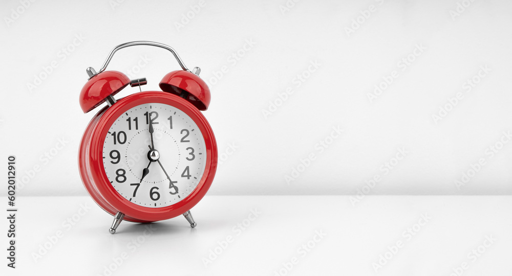 Red alarm clock on white wall background Red alarm clock on white wall background
