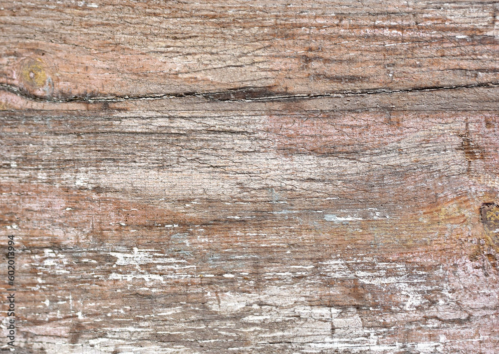 Abstract background of cracked weathered old wood with layers of paint