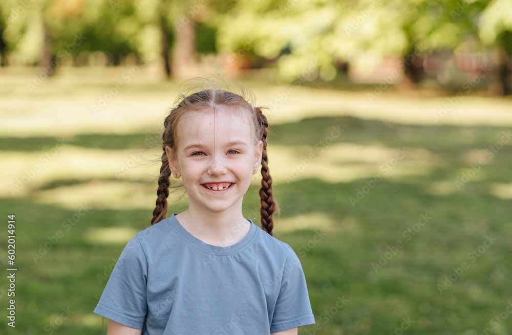 Portrait of a happy little girl in the park on a sunny day Portrait of a happy little girl in the park on a sunny day