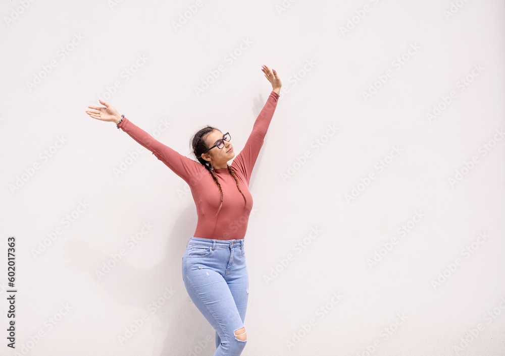 happy young adult woman on white wall background outdoors