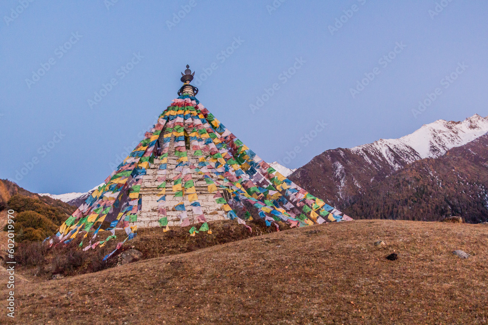 Stupa with prayer flags in Haizi valley near Siguniang mountain in Sichuan province, China