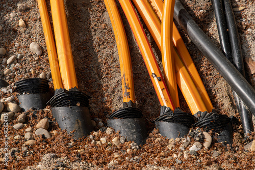 Fibre optic cable and district heating is laid in the street orange cable