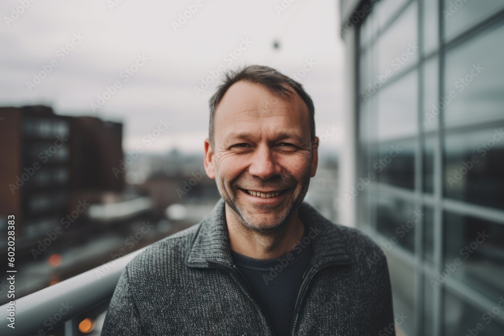 Portrait of a smiling middle-aged man against the background of a modern building Portrait of a smiling middle-aged man against the background of a modern building