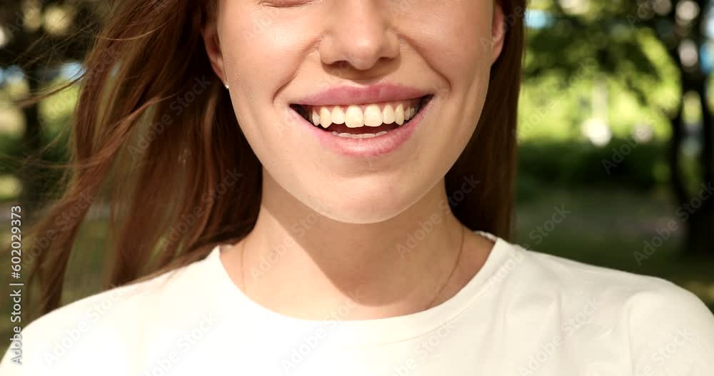 Closeup face of beautiful smiling woman with long hair. Portrait of gorgeous girl looking to camera. Closeup face of beautiful smiling woman with long hair. Portrait of gorgeous girl looking to camera.