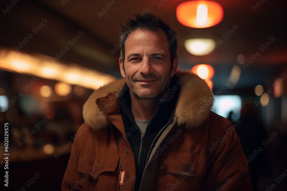 Portrait of handsome man in winter jacket looking at camera and smiling Portrait of handsome man in winter jacket looking at camera and smiling