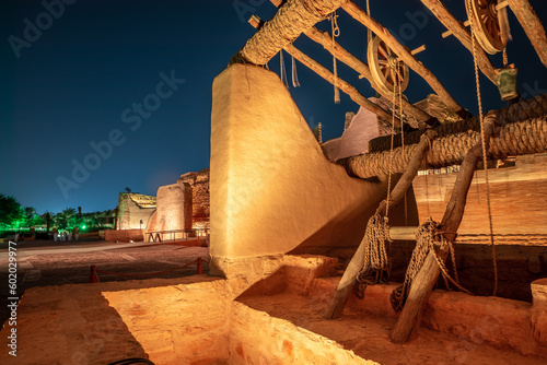 Diriyah old town well with highlighted wall in the background at night, Riyadh, Saudi Arabia photo