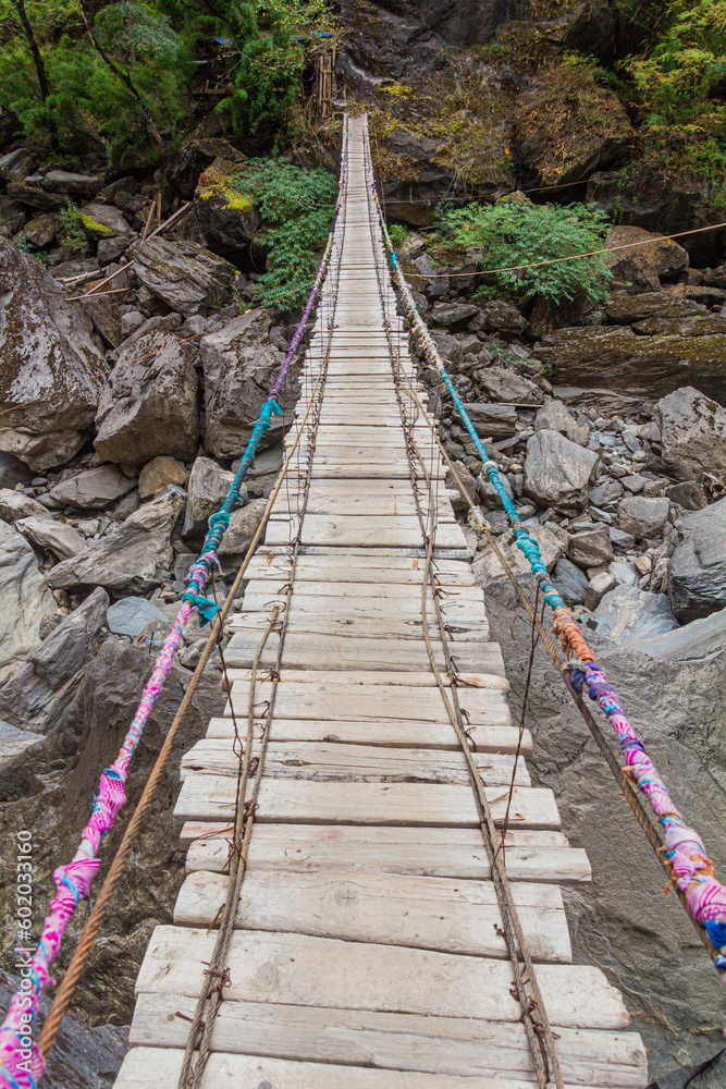 Hanging foot bridge over Jinsha river in Tiger Leaping Gorge, Yunnan province, China