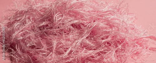 pink trend color with textile texture on pink background close up 